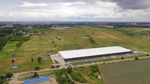Aerial panoramic view on innovative plant in nature. Modern factory building in the countryside.