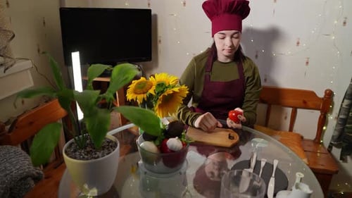 Woman Chef Cuts Tomato in Home Kitchen