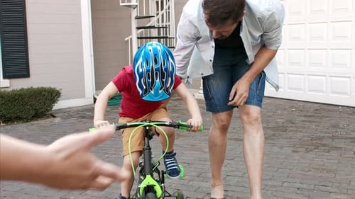 Father Teaches Son Bike Riding at Home