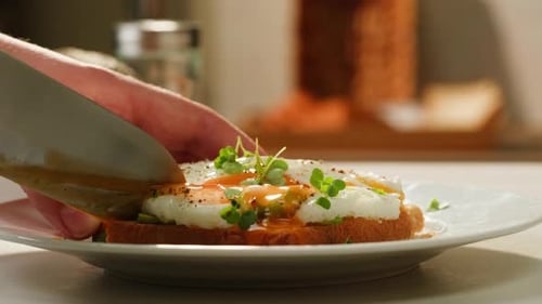 Hand Cuts Egg Avocado Toast with Knife