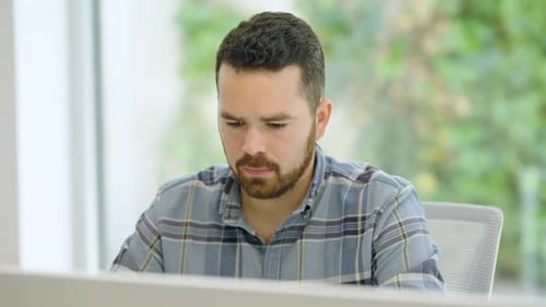 Focused Employee Working on Computer in Office