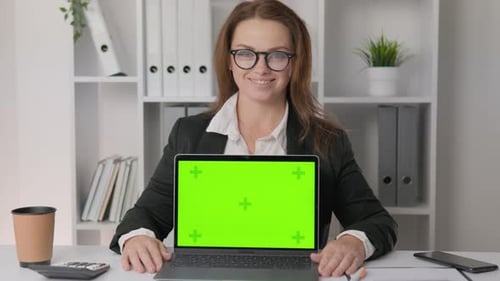 Chroma Key Green Screen Layout Confident Woman in Office with Documents and Laptop Strategically