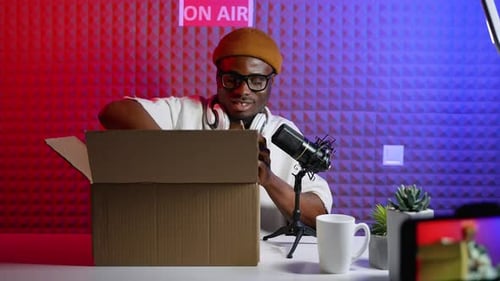 Enthusiastic Adult Unboxes Phone During a Broadcast