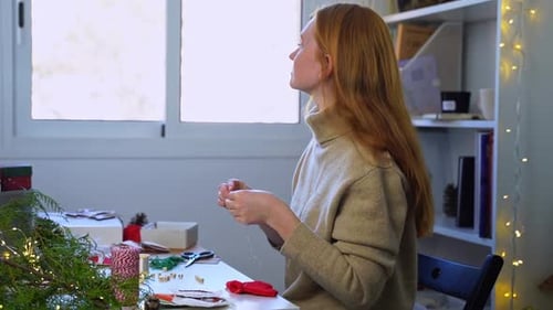 Woman Crafting Christmas Decorations at Home