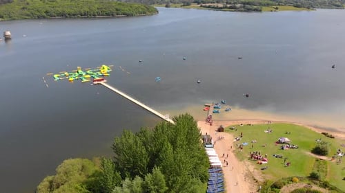 inflatable aqua park floating on Bewl Water reservoir on sunny day aerial