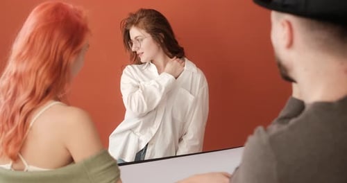 Female Model on the Photo Shoot in the Studio with Male Photographer and Assistant