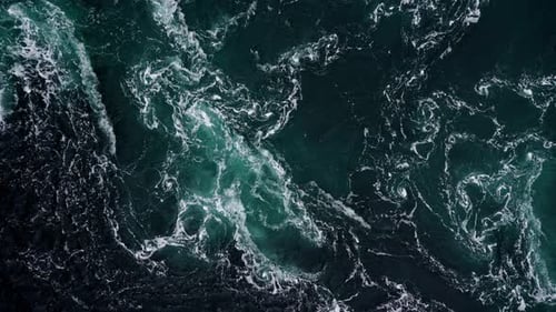 Drone Video with Birdseye View of the Abstract and Powerful Water Currents Rapids and Whirlpools of