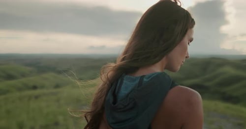 Woman Relax Green Hills Landscape at Sunset