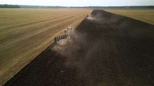 Tractors plowing the field in Ukraine
