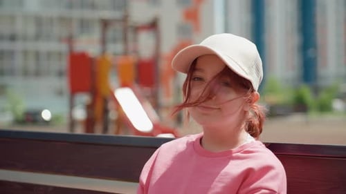 Youthful Casual Portrait Young Woman On Bench Smiling Softly Outdoors Young Woman Resting On Park