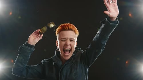 Woman Celebrates Success Under Stage Lights