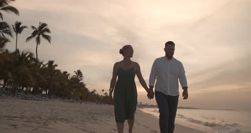 Romantic sunset beach walk in the caribbean for honeymooning couple
