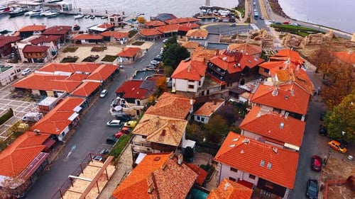 A coastal town filled with houses that have red roofs. The buildings are close together