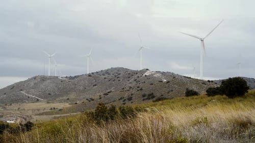wind turbines generate energy on a cold windy day