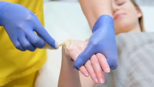 Woman Receiving Soothing Hand Treatment at Spa