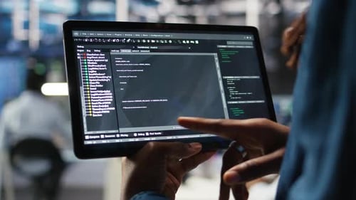 Close Up of Data Center Software Developer Checking Code on Tablet