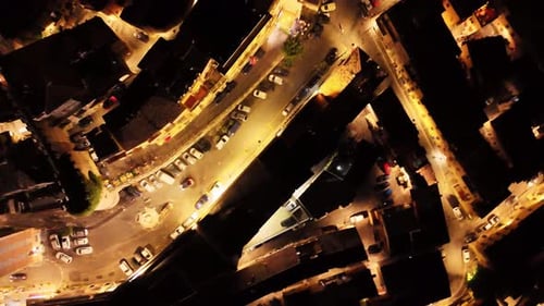 Camera rotating over small european town at night