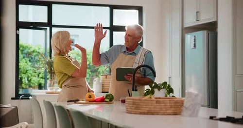 Senior Couple Celebrating Together in Modern Bright Kitchen