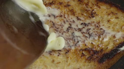 Close-up Butter Spread on Toast in Home Kitchen