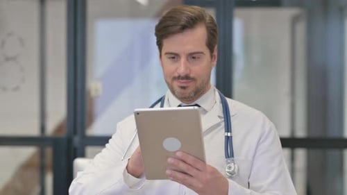 Portrait of Young Doctor Using Digital Tablet