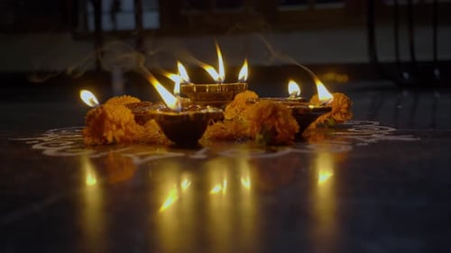 Glowing Diya Lamps and Marigold Flowers