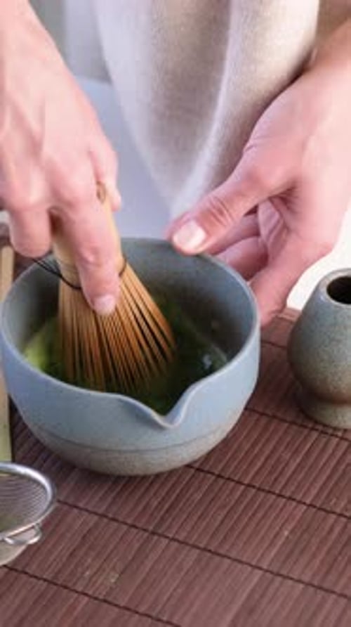 Preparing Traditional Matcha Tea with Bamboo Whisk