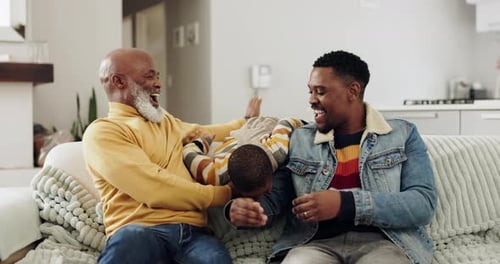 Happy Family Playing Together on Sofa