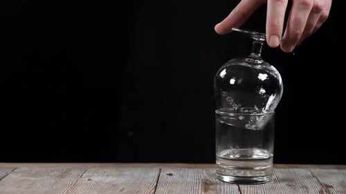 Martini Glass Overflows Water into Glass
