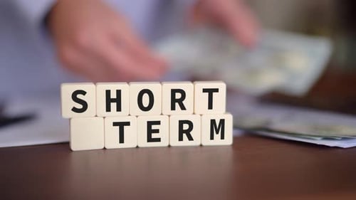 Concept of short term investment. Selective focus and a person counting cash on the background.