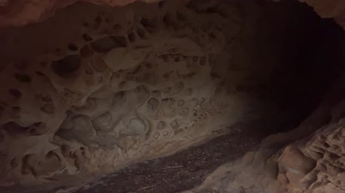 Getting out walk from inside the cave, stony and rocky surface of an old-time structure, raw natural