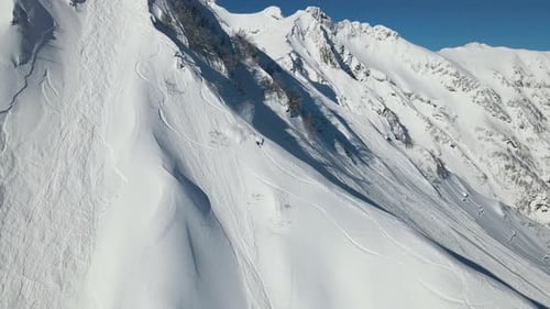 Aerial a Freerider Descends a Steep Unprepared Slope at High Speed