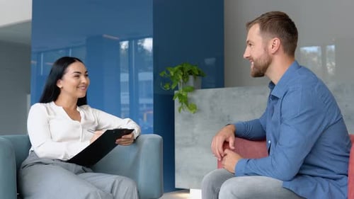 Man and Woman in Modern Office Talking