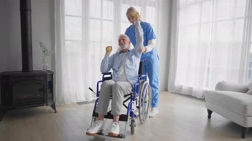 Senior Man Exercising with Assistance in Wheelchair
