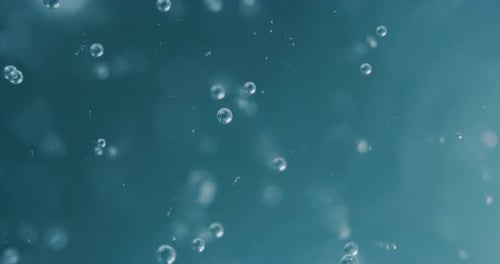 Slow motion macro of micro particles molecules in a liquid are analyzed with microscope for resear