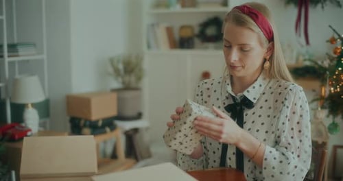 Joyful Woman Decorating Wrapping Christmas Gifts For Xmas Holidays