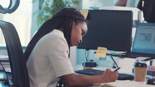 Writing, business woman and marketing employee working on a office schedule in a notebook