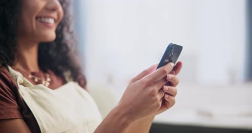 Woman, hands and typing with phone on sofa for text message, social media post