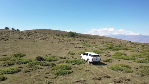 Aerial View Of Offroad Vehicle Climbing Mountain
