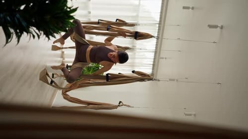 Woman Doing Aerial Yoga in Hammock