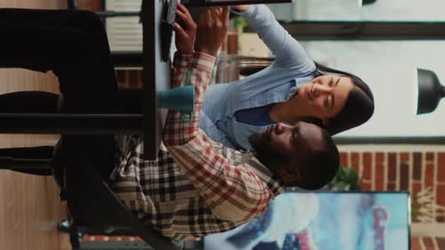 Vertical Video Diverse Engineers Working on Turbine Component with Modern Electronics