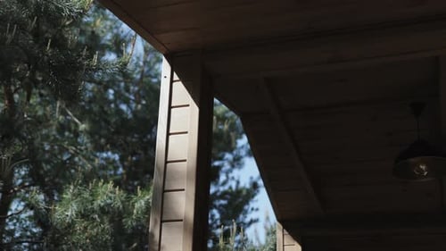 Closeup of the Part of Wooden House Built Near the Pine Forest House Wooden Roof Beam in Shadow Slow