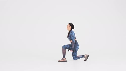 Young woman goes in for sports, fitness. Side view. fitness trainer in sportswear performs exercises