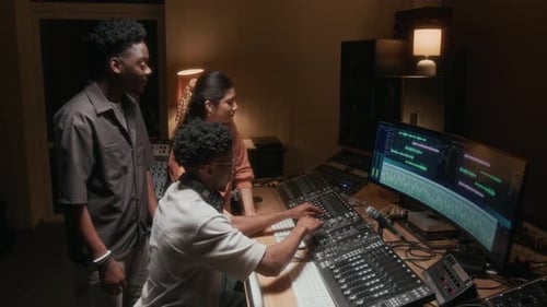 Sound Engineer Editing Tracks at Mixing Console