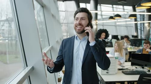 Caucasian Businessman in His 40s Standing By the Window in the Office