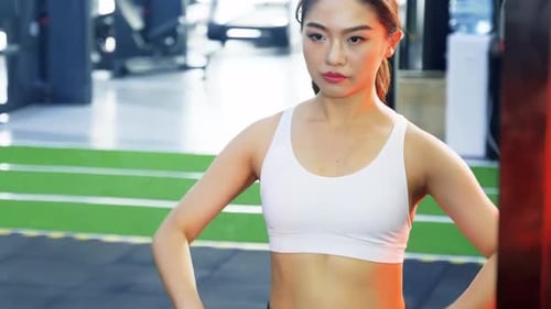 Portrait Asian woman in sportswear do workout exercise weight lifting barbell at fitness gym sport.