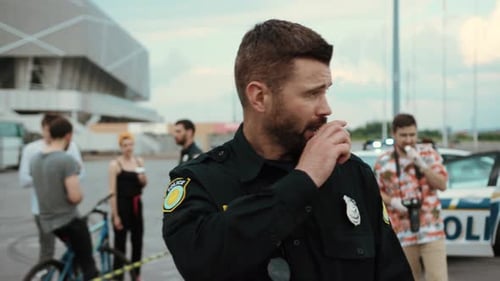 Police Officer Communicates on Radio at Crime Scene