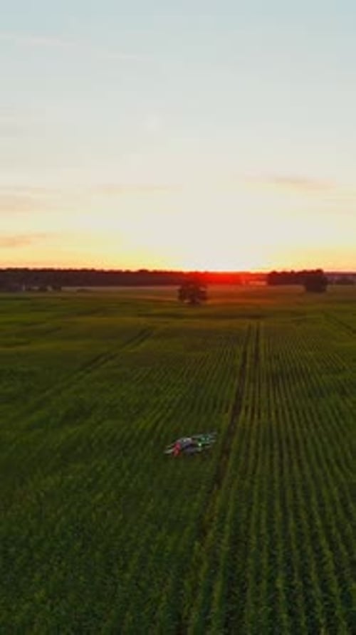 Agriculture drone flying at sunrise over field with modern technology - vertical