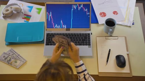 Happy trader counting money.