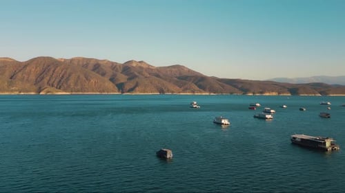 Aerial drone flying over a lake, water dam, with mountains at sunrise. Beautifull dreamy landscape v