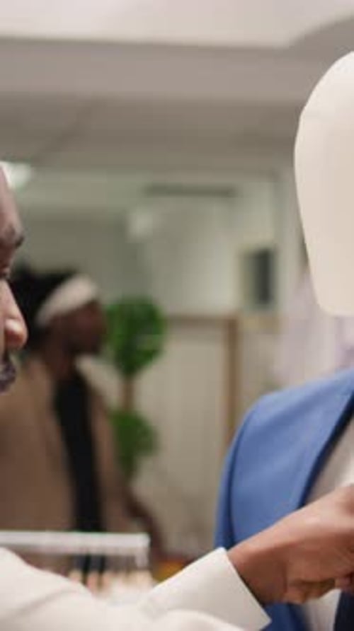 Salesperson Adjusts a Stylish Blue Suit Jacket